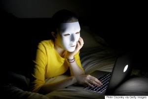 Anonymous teenager in mask on internet at night